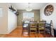 Inviting dining room with a wooden table, a large clock, and a stylish beverage area, perfect for gatherings at 4705 Andes St, Denver, CO 80249