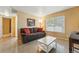 Relaxing living room with a plush couch, bright window, and an inviting atmosphere at 4705 Andes St, Denver, CO 80249