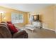 Comfortable living room with a large window, plush couch, and an entertainment area at 4705 Andes St, Denver, CO 80249