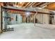 Unfinished basement featuring exposed beams and concrete floor, offering potential for customization and extra space at 10832 Montvale Cir, Highlands Ranch, CO 80130