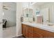 Bathroom with double sinks and wood cabinets, offers modern features and clean design at 10832 Montvale Cir, Highlands Ranch, CO 80130