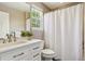A bathroom featuring a white vanity with a stone countertop and a shower with a curtain at 10832 Montvale Cir, Highlands Ranch, CO 80130