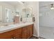 Bathroom with double sinks and wood cabinets, offers modern features and clean design at 10832 Montvale Cir, Highlands Ranch, CO 80130