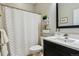 Clean and modern bathroom with a shower curtain, storage shelves, and a sleek vanity at 10832 Montvale Cir, Highlands Ranch, CO 80130