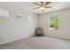Bright bedroom with a ceiling fan and chair, with a three windows providing plenty of light at 10832 Montvale Cir, Highlands Ranch, CO 80130