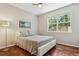 Well-lit bedroom featuring hardwood floors, large window with natural light, and contemporary decor at 10832 Montvale Cir, Highlands Ranch, CO 80130