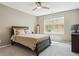 Cozy bedroom with neutral tones, a ceiling fan, and a comfortable bed with soft bedding at 10832 Montvale Cir, Highlands Ranch, CO 80130