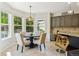 Eat-in kitchen with tile floors, four chairs and views of exterior landscape at 10832 Montvale Cir, Highlands Ranch, CO 80130