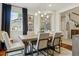 Bright dining room with a view to a modern staircase and stylish light fixture at 10832 Montvale Cir, Highlands Ranch, CO 80130