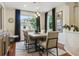 Beautiful dining room featuring hardwood floors, modern light fixtures, and a view of the front yard at 10832 Montvale Cir, Highlands Ranch, CO 80130