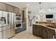 Kitchen with stainless steel appliances, granite countertops, a large island, and tile flooring throughout at 10832 Montvale Cir, Highlands Ranch, CO 80130