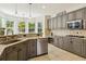 Spacious kitchen with stainless steel appliances, granite countertops, tile floors, and ample natural light at 10832 Montvale Cir, Highlands Ranch, CO 80130
