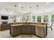 Stylish kitchen with granite countertops, stainless steel appliances, island seating, and open-concept design at 10832 Montvale Cir, Highlands Ranch, CO 80130