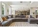 Open-concept living room flows into the kitchen, featuring a large sectional sofa and plenty of natural light at 10832 Montvale Cir, Highlands Ranch, CO 80130