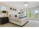 Bright main bedroom with a large bed, balcony doors, and plenty of natural light at 10832 Montvale Cir, Highlands Ranch, CO 80130