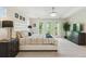 Bright primary bedroom with a large bed, balcony doors, and ceiling fan at 10832 Montvale Cir, Highlands Ranch, CO 80130