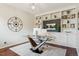 Modern office space featuring a glass desk, custom built-ins, and ample lighting at 10832 Montvale Cir, Highlands Ranch, CO 80130