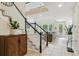 Staircase leading to a bright living area with tile floors and lots of natural light at 10832 Montvale Cir, Highlands Ranch, CO 80130