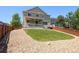 Expansive backyard featuring a well-manicured lawn, and a charming covered patio at 1382 Raindrop Way, Castle Rock, CO 80109