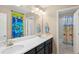 Bathroom with double sink vanity, large mirror, and shower with tub at 1382 Raindrop Way, Castle Rock, CO 80109