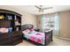 Cozy bedroom with ceiling fan, window, curtains, and furniture storage at 1382 Raindrop Way, Castle Rock, CO 80109