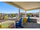 Charming front porch featuring colorful Adirondack chairs and neighborhood views at 1382 Raindrop Way, Castle Rock, CO 80109