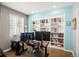 Bright home office featuring custom built-ins, hardwood floors, and modern decor at 1382 Raindrop Way, Castle Rock, CO 80109