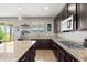 Modern kitchen with granite countertops, stainless steel appliances, and dark cabinetry at 1382 Raindrop Way, Castle Rock, CO 80109