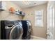 Functional laundry room with front loading washer and dryer at 1382 Raindrop Way, Castle Rock, CO 80109