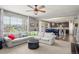 Open-concept living room and kitchen features a large sofa, ceiling fan, and natural light at 1382 Raindrop Way, Castle Rock, CO 80109