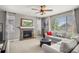 Bright living room featuring a stone fireplace, large windows, and comfortable seating at 1382 Raindrop Way, Castle Rock, CO 80109