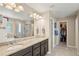 Spacious main bathroom featuring dual sinks, a walk-in closet, and separate shower and tub at 1382 Raindrop Way, Castle Rock, CO 80109