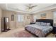 Elegant main bedroom with tray ceiling, ceiling fan, and ample natural light at 1382 Raindrop Way, Castle Rock, CO 80109