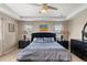Elegant main bedroom with tray ceiling, ceiling fan, and ample natural light at 1382 Raindrop Way, Castle Rock, CO 80109