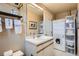 Bathroom with a vanity, mirror, organized storage, and in-unit laundry appliances at 960 N Sherman St # 3F, Denver, CO 80203