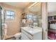 Bathroom with a vanity, toilet, mirror, and a glass-enclosed shower, with a view to the closet at 960 N Sherman St # 3F, Denver, CO 80203