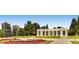 Panoramic view of City Park's iconic Greek Theater and colorful flower beds on a sunny day, with city buildings in the background at 960 N Sherman St # 3F, Denver, CO 80203