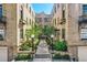 Inviting brick courtyard featuring mature landscaping, pathways, and decorative lighting at 960 N Sherman St # 3F, Denver, CO 80203