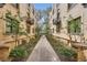 Exterior view along walkway featuring manicured landscaping and charming brick architecture at 960 N Sherman St # 3F, Denver, CO 80203
