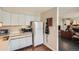 Bright kitchen adjacent to a cozy living area, complete with essential appliances and tile flooring at 960 N Sherman St # 3F, Denver, CO 80203