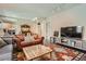 Spacious living room with a TV, modern furniture, and an adjacent dining area at 960 N Sherman St # 3F, Denver, CO 80203
