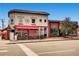 Corner shopfront of a restaurant with an outdoor red awning and patio seating, offering Nashville style chicken and beer at 960 N Sherman St # 3F, Denver, CO 80203