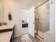 Bathroom with a glass-enclosed shower and a view into the main bedroom at 13261 E 110Th Pl, Commerce City, CO 80022