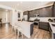 Modern kitchen featuring an island, stainless steel appliances, and dark cabinets at 13261 E 110Th Pl, Commerce City, CO 80022