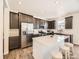 Bright kitchen with stainless appliances, large island with seating, and modern finishes at 13261 E 110Th Pl, Commerce City, CO 80022