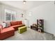 Bright living room with comfortable seating, a bookshelf, and plenty of natural light at 13261 E 110Th Pl, Commerce City, CO 80022