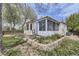 Landscaped backyard with garden beds and a bright sunroom at 2556 E 131St Pl, Thornton, CO 80241