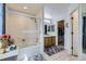 Bright bathroom featuring a tub, shower, and access to a walk-in closet at 2556 E 131St Pl, Thornton, CO 80241