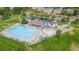 Aerial view of community pool with lounge chairs and playground at 2556 E 131St Pl, Thornton, CO 80241