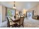 Open dining area with ample seating, stylish chandelier, and seamless flow to the living room at 2556 E 131St Pl, Thornton, CO 80241